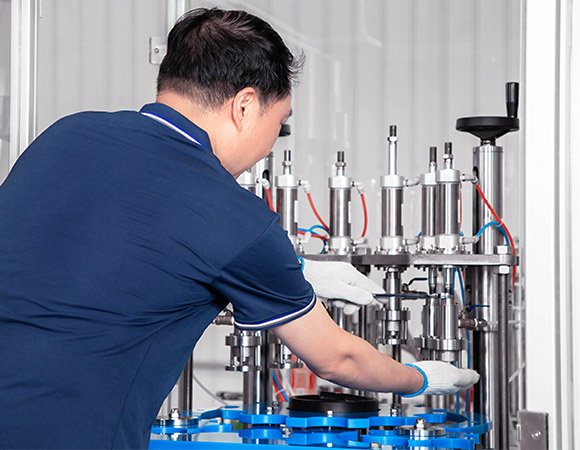 An engineer is maintaining a aerosol filling machine